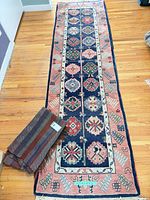 Full view of rug runner with throw beside it on hardwood floor
