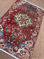 Full view angled of Hamedan rug showing pattern and fringe