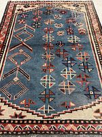 Full view of blue Shiraz rug showing pattern and borders