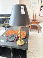 Full view of brass candlestick style lamp and shade