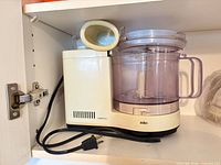 Left side view of Braun food processor showing base, bowl, pusher and cord