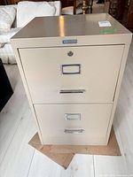 Front view showing two drawers with handles and lock