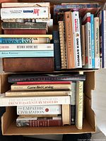 Top view of box showing assortment of books with titles visible