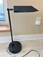 Full view of lamp showing base, arm, shade, cord