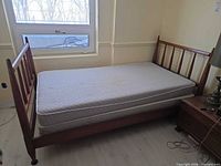 Full view of assembled twin bed with headboard, footboard, mattress and box spring