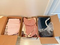 Three boxes with fabrics and quilted pads visible