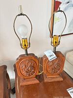 Pair of carved wood floral table lamps with bulbs and harps