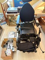 Full view of Quantum Q6 Edge wheelchair with accessories on floor