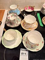 All six teacup and saucer sets displayed