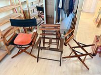 Group shot showing three director chairs and folding stool