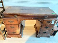 Front view of desk showing overall design and seven drawers