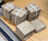 Stacks of square travertine tiles bound with plastic straps