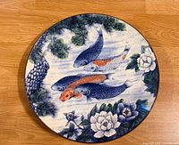 Front view showing koi, lotus and pine design on round platter