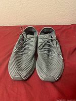 Top view of both sneakers showing mesh grid upper and laces