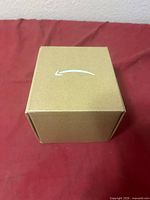 Sealed brown Amazon box top view with smile logo