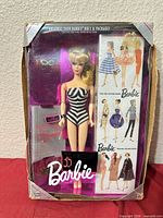 Front view of boxed Barbie doll and accessories