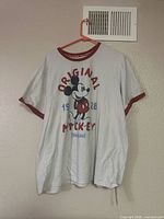 Front view of T-shirt showing Mickey Mouse graphic and text