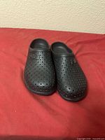 Top view of both black Fila Impel Slide clogs