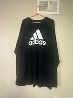 Front view of black Adidas Climalite long-sleeve tee with white logo