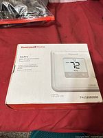 Front of retail box showing Honeywell Home T1 Pro thermostat image and model TH1110D2009