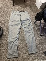 Full view of sweatpants laid flat on floor