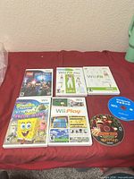 All six cased games and two loose discs laid out on red surface