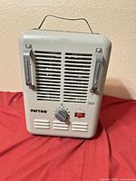 Front view showing brand name, controls, vents, side guards and carry handle