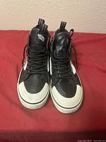 Front view of both sneakers showing laces, toe caps, tongue logos