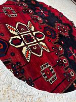 Angled close-up of rug highlighting pile, weave and geometric design