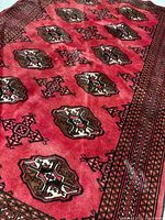 Angle view highlighting wool pile, color tones and gul motifs