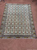 Full view of Torkaman carpet on floor showing overall pattern and borders