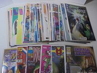 Stack of bagged comic books showing variety of titles and publishers