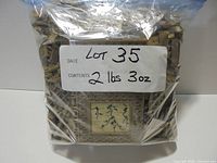 Ziplock bag containing dark tan Lego parts, label showing Lot 35 and weight 2 lbs 3 oz