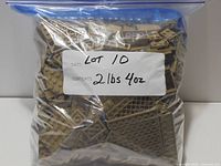 Sealed zipper bag filled with dark tan LEGO pieces, handwritten label noting lot number and weight 2 lbs 4 oz