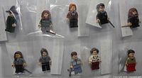 Overview of nine of the ten bagged minifigures in two rows