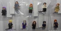 All ten minifigures arranged in two rows inside bags