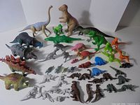 Full group of assorted plastic and rubber dinosaur figures displayed