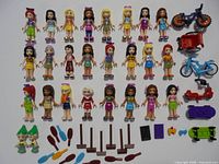 Full lot showing 26 mini-dolls, vehicles and accessories