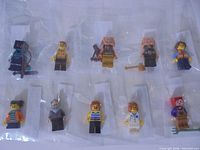 Ten bagged LEGO minifigures displayed in two rows