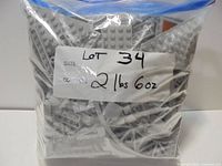 Sealed zip bag of grey LEGO pieces with weight label