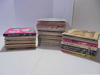 Three stacks of 7-inch 45 rpm records with sleeves