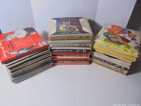 Three stacks of over 100 7-inch records with printed spines visible