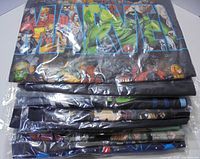 Stack of 11 folded graphic t-shirts in clear bags