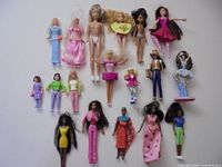 Group shot showing all 18 dolls and figures arranged on white surface