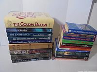 Two stacks showing all 20 books, hardcovers on left, paperbacks on right