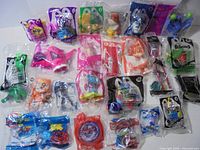 Overall shot of 25 unopened fast-food premium toys laid out in 5 × 5 grid