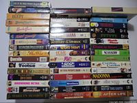 Entire group of VHS tapes stacked showing titles and quantity