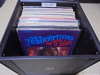 Top view of crate filled with LPs, front record Temptations "With A Lot O’ Soul"