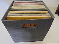 front view of grey fabric cube filled with LP records