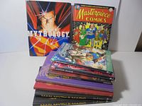 All nine hardcover books stacked, front covers of top titles visible